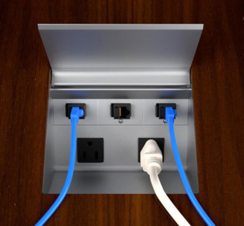 Production version of the power cove with Ethernet and power cords plugged in