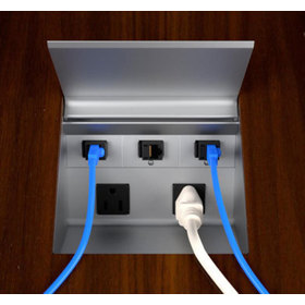 Production version of the power cove with Ethernet and power cords plugged in