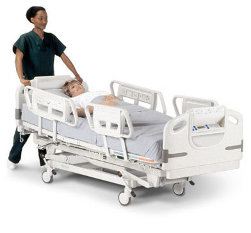 Advanta Hospital Bed with a patient lying down being pushed by a nurse