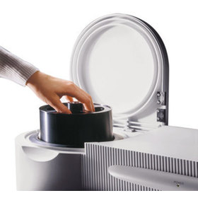 Image showing the unit open and a user's hand removing a storage canister
