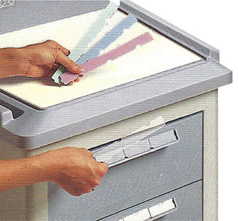 Detail close up view showing how color-coded labels can be inserted into drawers on the small medical cart