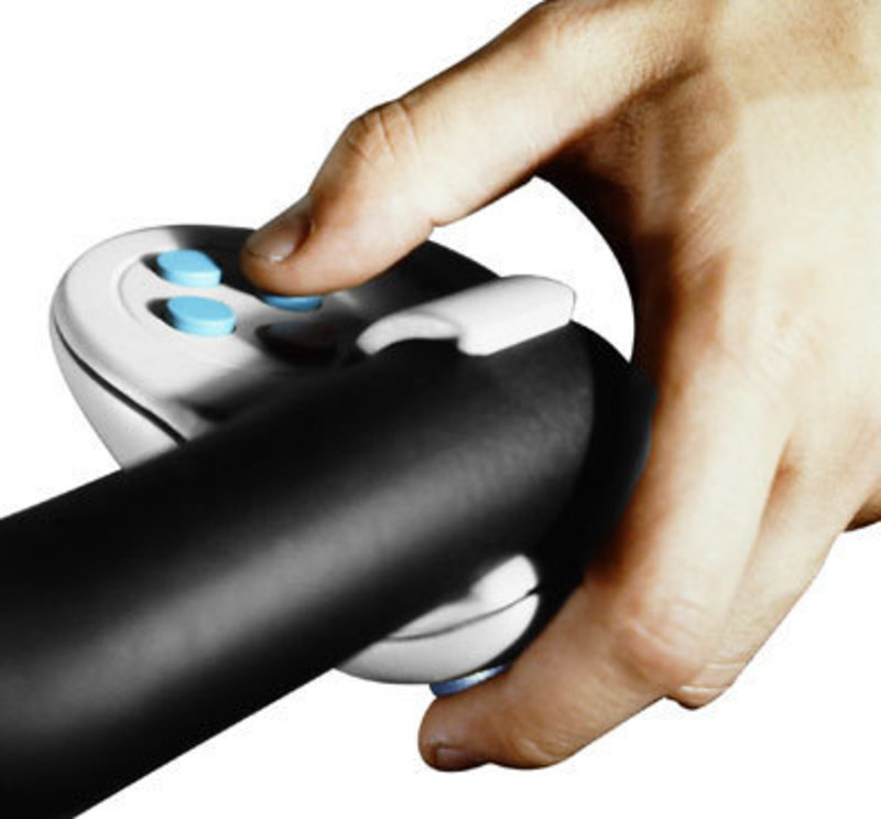 Close up view showing a user's hand pressing input buttons on the controller