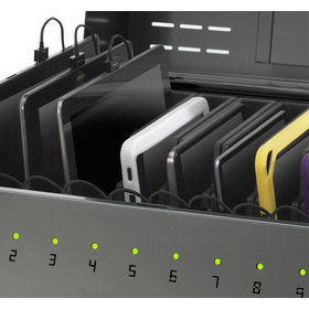 Close-up of the open charging tray showing different devices charging