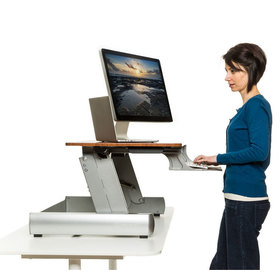 Side view of the InMovement desktop with a person using it on a desk
