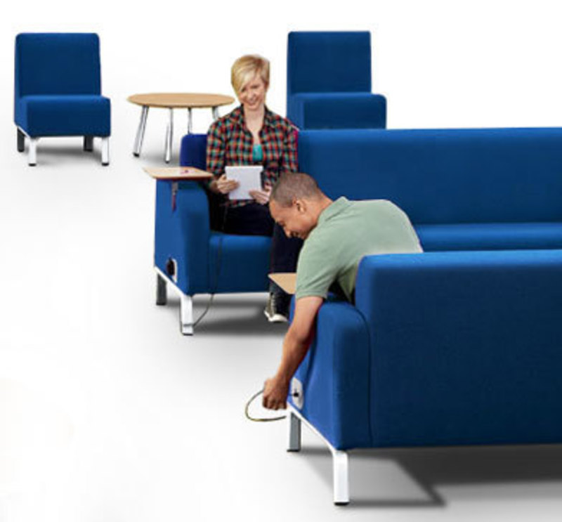 Context view showing people using charging ports on Bretford furniture